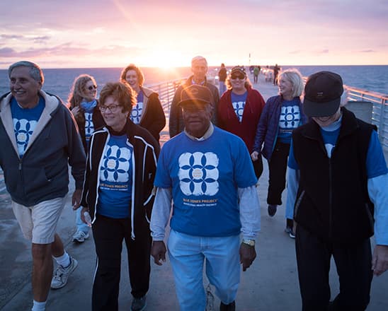 Group of adults walking at sunset